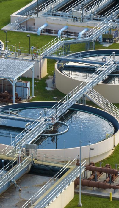 Aerial view of modern water cleaning facility at urban wastewater treatment plant. Purification process of removing undesirable chemicals, suspended solids and gases from contaminated liquid.