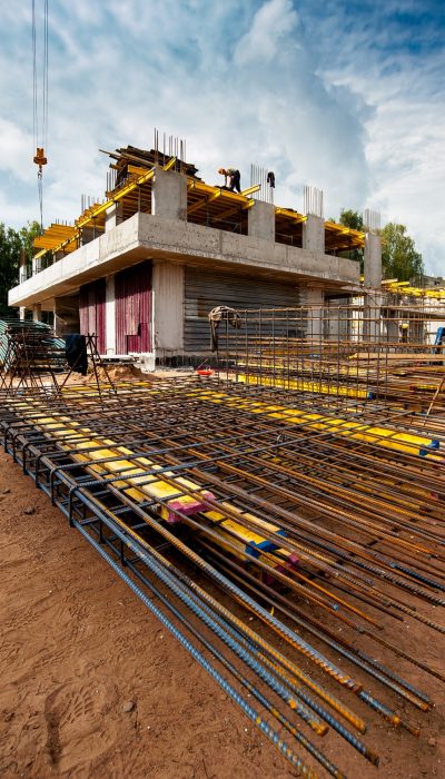 reinforced-frame-foreground-new-monolithic-house-construction-against-blue-sky